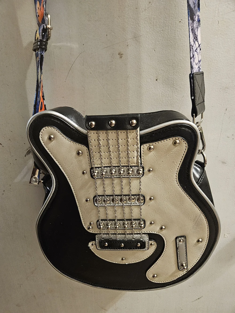 Black and Cream Guitar-Shaped Crossbody Bag with Graphic Strap